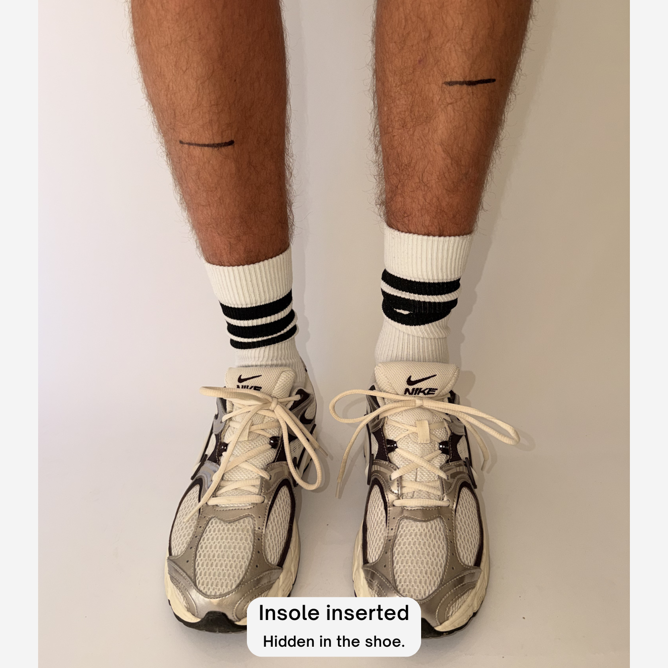 Öndörq Elevate invisible height insoles for men in one shoe with lines drawn on  the persons shins indicating the height gain.

